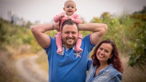 A cheerful family of three, enjoying a day outdoors. Perfect for family, happiness, and togetherness concepts.