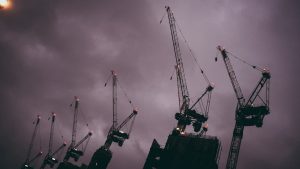 silhouette of crane under cloudy sky during daytime